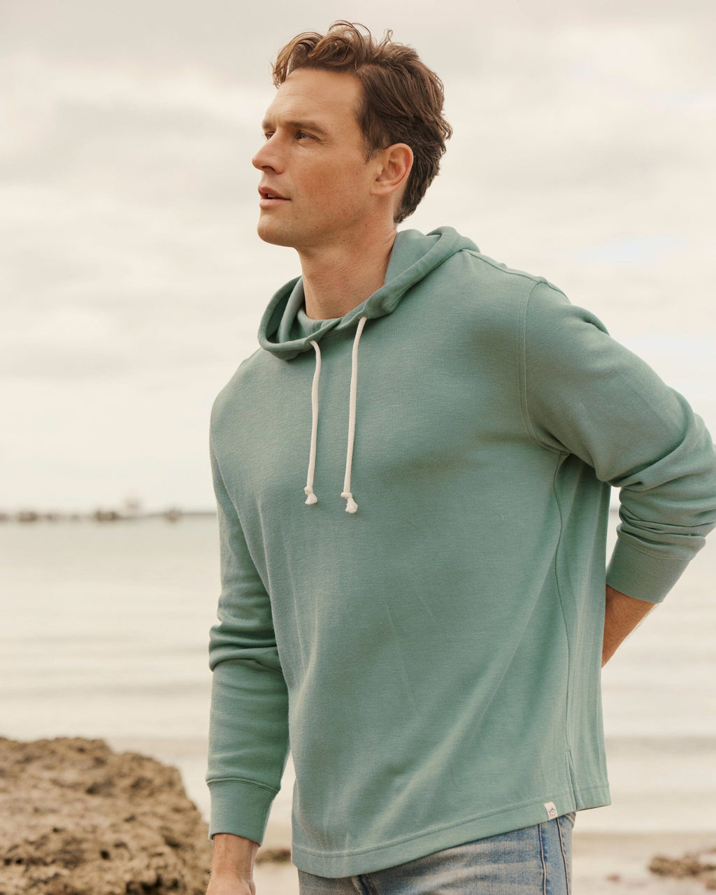 The lifestyle view of the Southern Tide Bay View Hoodie by Southern Tide - Seafoam Green